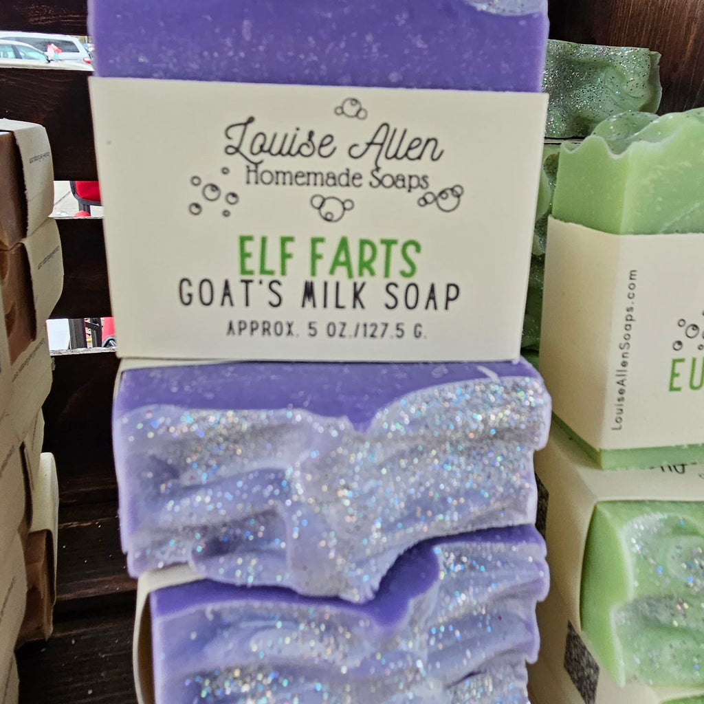 Purple goat's milk soap with glittery texture and a label for 'Elf Farts' soap from Louise Allen Homemade Soaps.