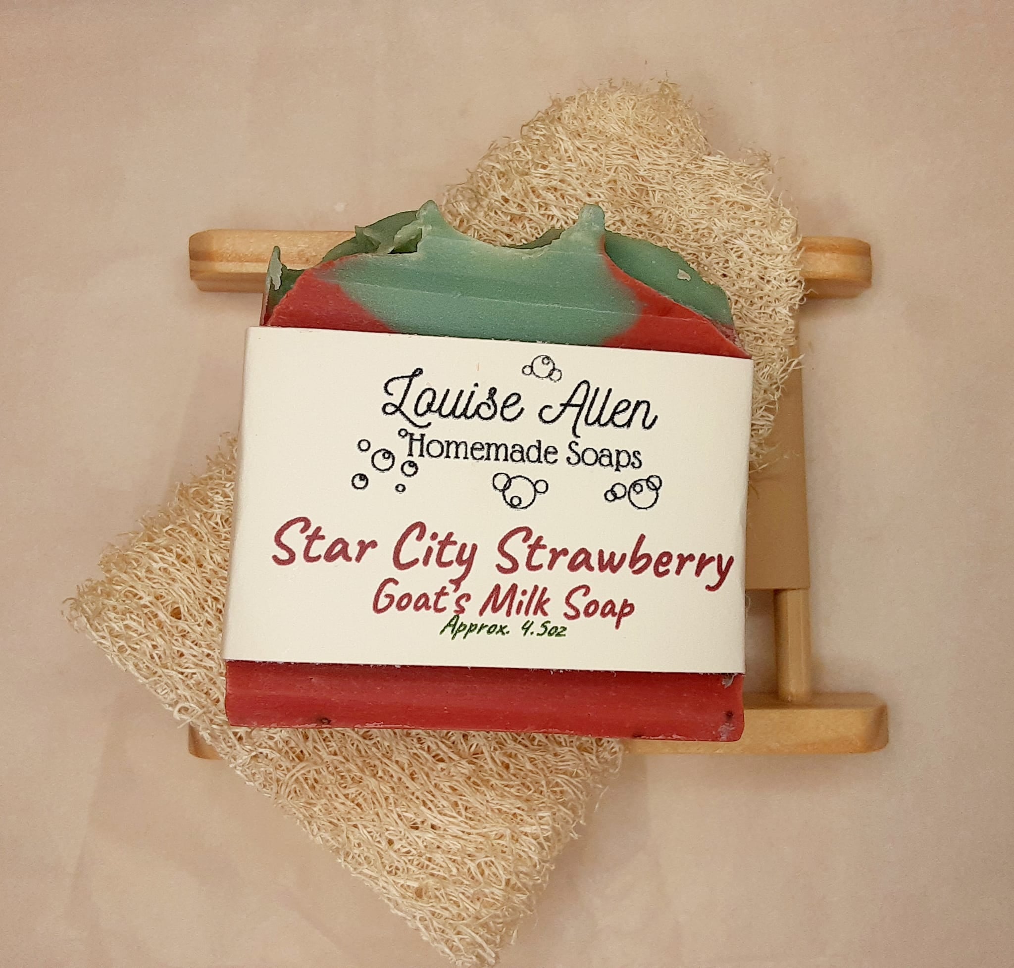 Bar of soap with 'Louise Allen Homemade Soaps' branding on a wooden holder.