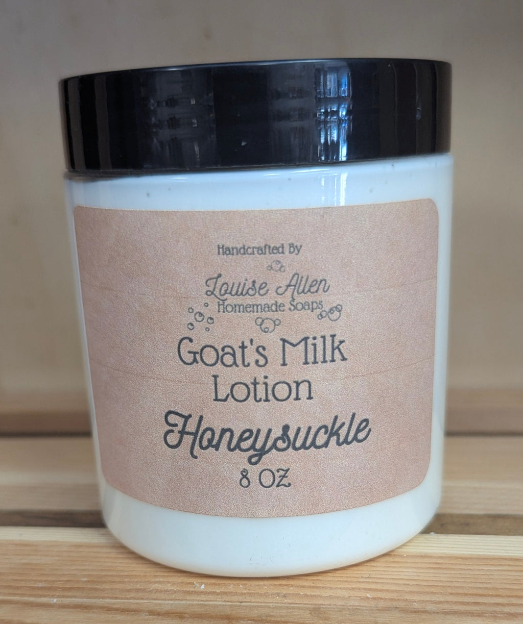 Goat's Milk Lotion Honeysuckle jar on a wooden surface