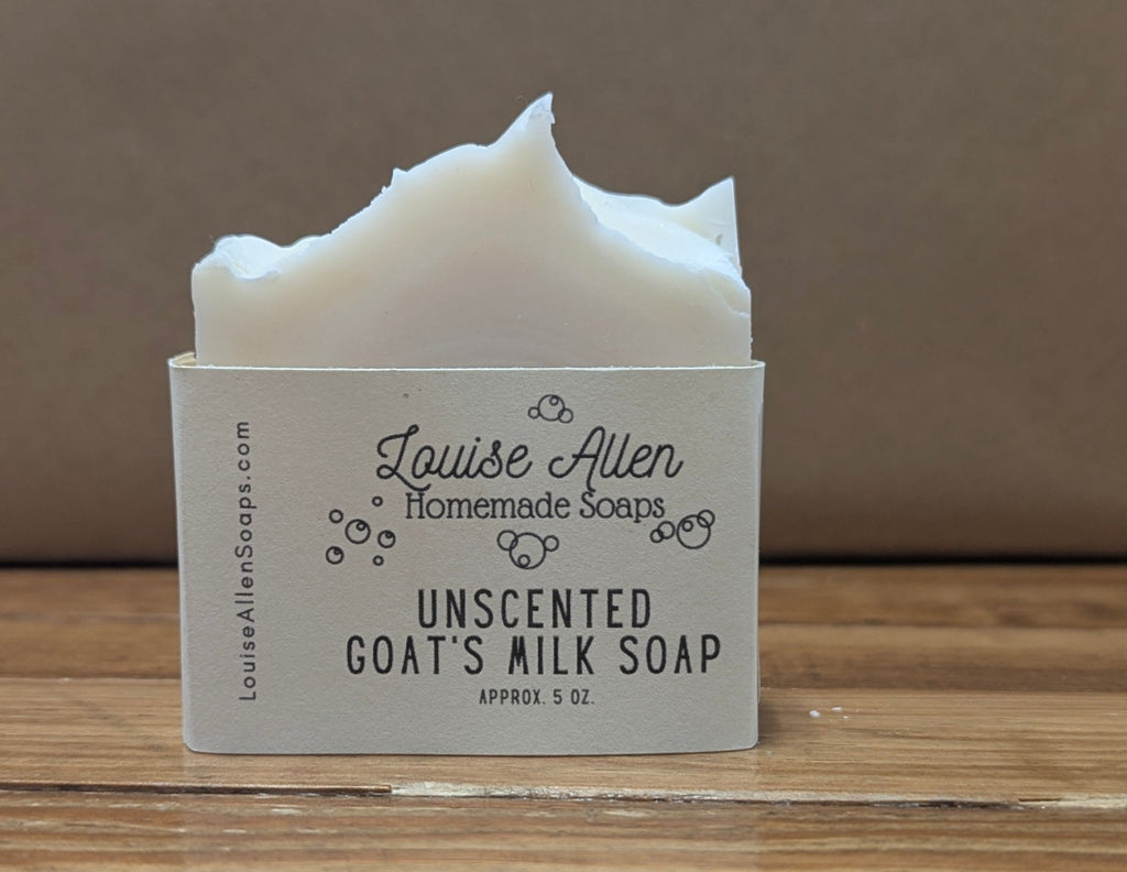 Bar of unscented goat's milk soap with a label on a wooden surface